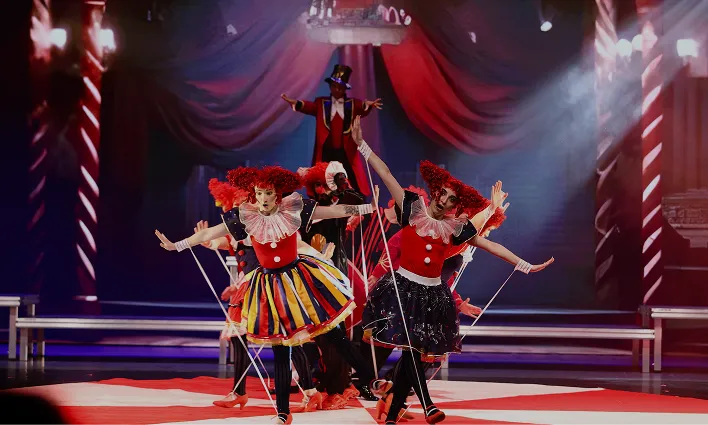 Dramatic live production with stage lighting and performers